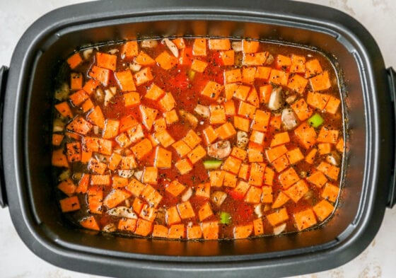 An overhead shot of the vegetable soup cooking in the slow-cooker.