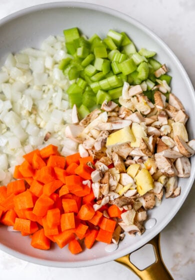 A saucepan with veggies in each quarter.