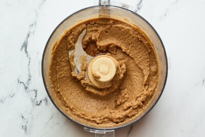Blended chickpea chocolate dip in a food processor.
