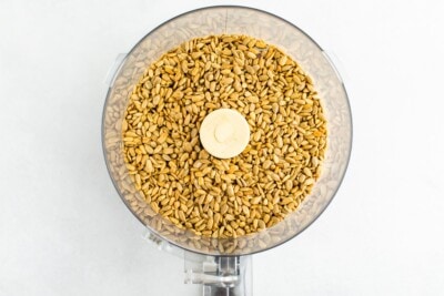 Overhead shot of sunflower seeds in a food processor.