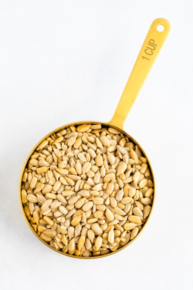 1 cup of sunflower seeds in a measuring cup.