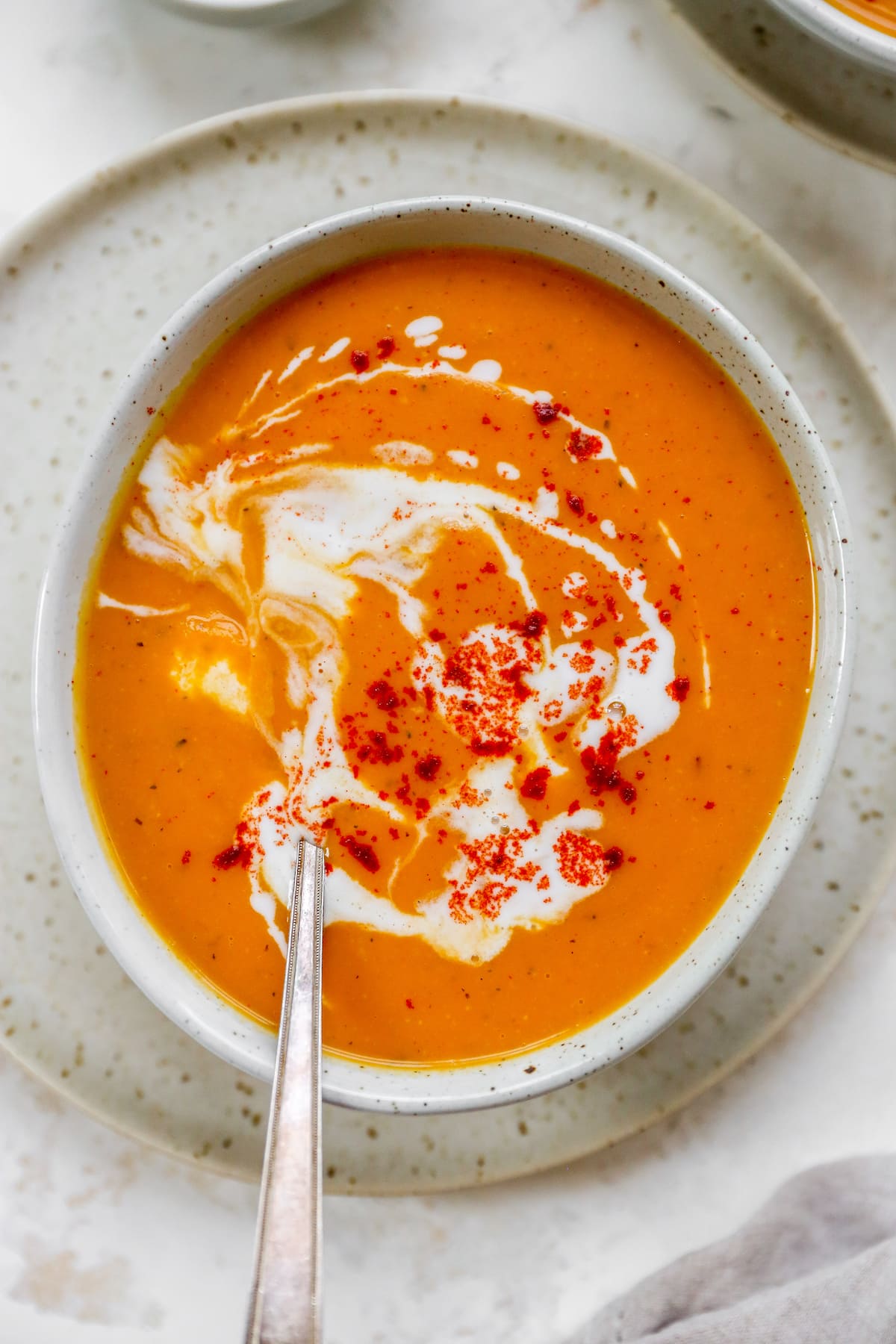 Overhead shot of a bowl of soup with a spoon resting inside the bowl.