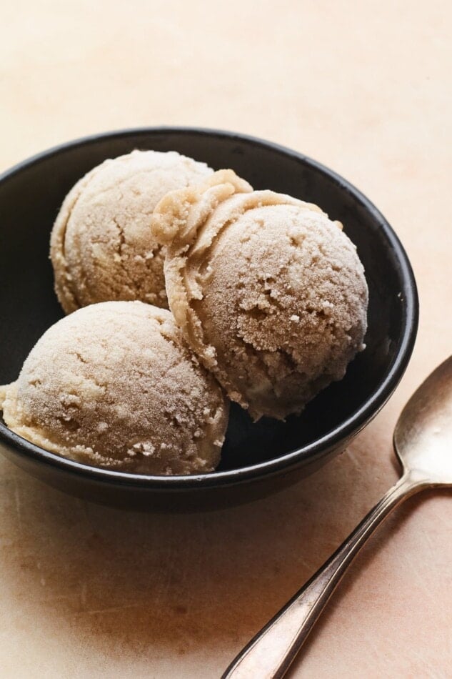 Three scoops of vanilla protein ice cream in a bowl.