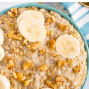 Bowl of steel cut oats topped with walnuts and banana slices.