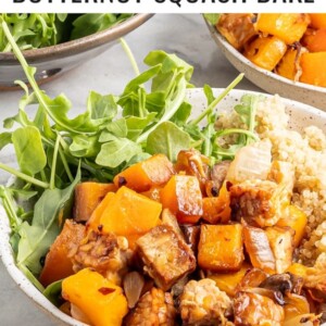 Overhead view of butternut squash tempeh bake served with quinoa and greens.