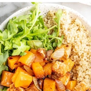 Overhead view of butternut squash tempeh bake served with quinoa and greens.