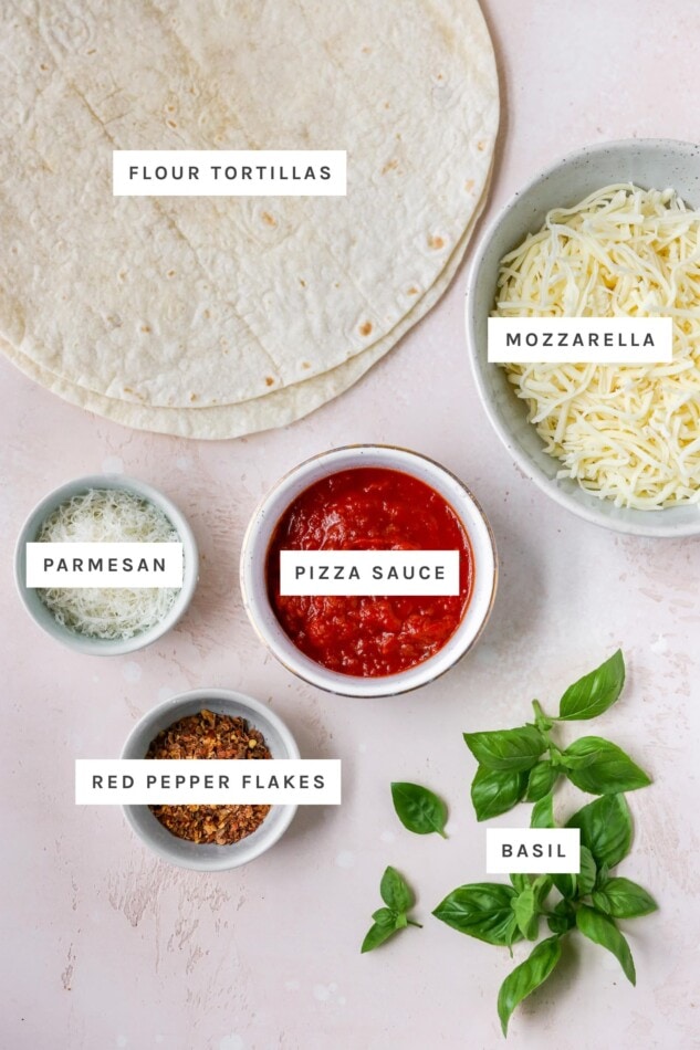 Ingredients measured out to make tortilla pizza: flour tortillas, mozzarella, parmesan, pizza sauce, red pepper flakes and basil.