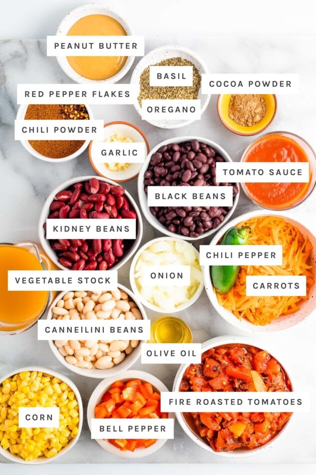 Ingredients measured out to make vegetarian chili like beans, spices, veggies, peanut butter, cocoa powder and veggie broth.