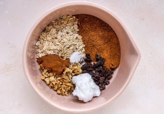 A mixing bowl with dry ingredients for a cinnamon oat filling.