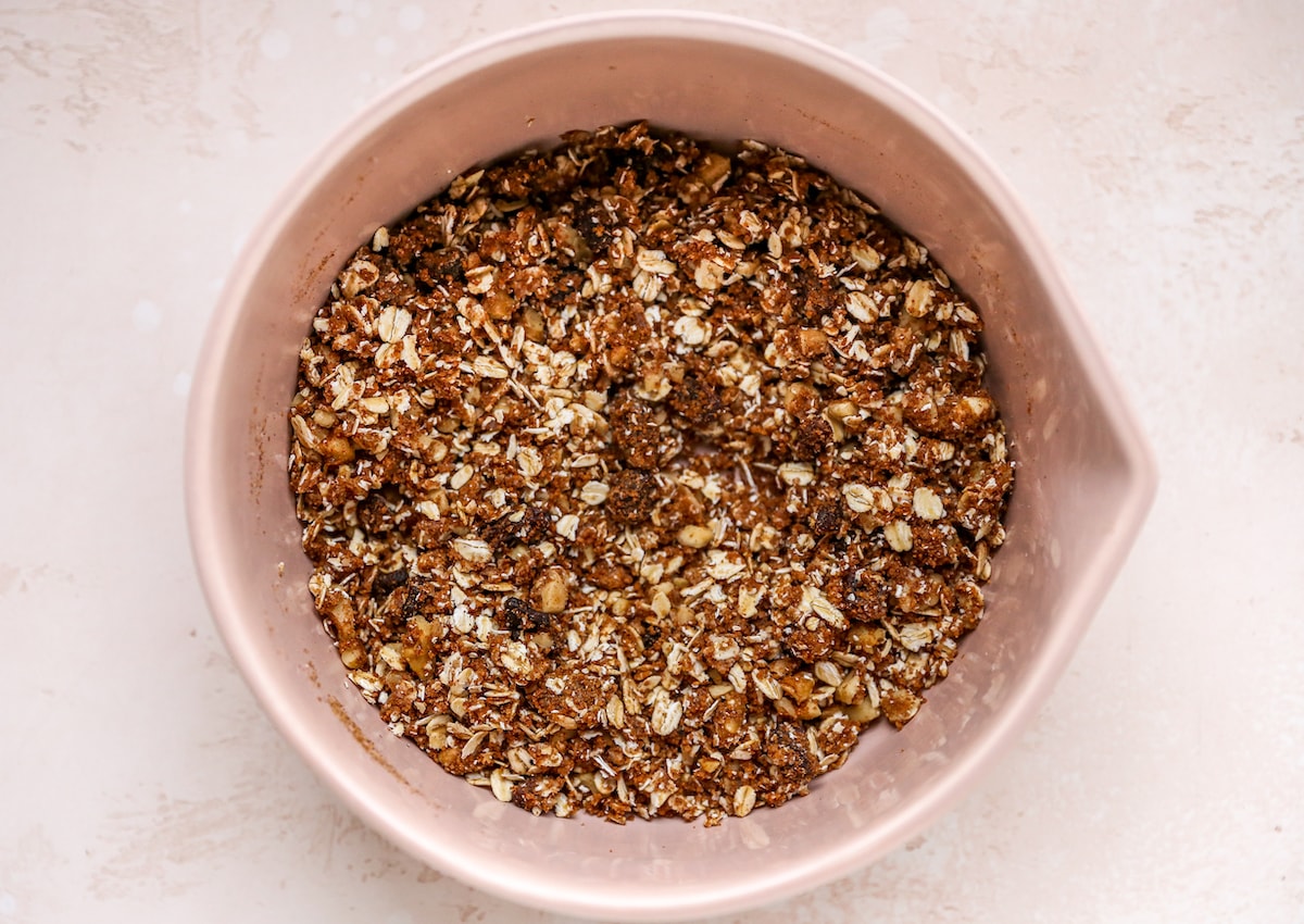 A mixing bowl with ingredients mixed together for a cinnamon oat filling.