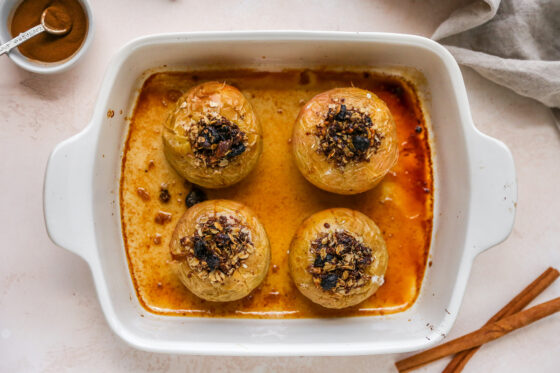 4 baked apples in a rectangular baking dish.