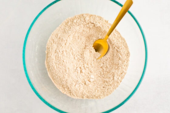 Dry ingredients in a bowl with a spoon.