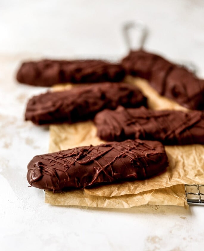 5 health Twix bars on a piece of brown parchment paper.