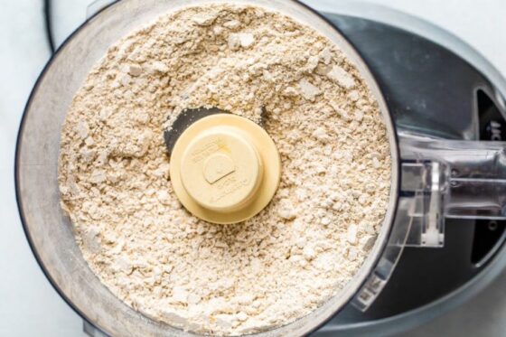 Food processor with blended oats that are now oat flour.