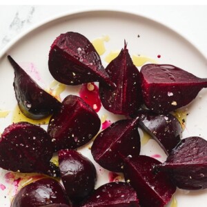 An overhead photo of a plate of quartered roasted beets.