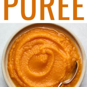 Bowl of butternut squash puree with a spoon in it.