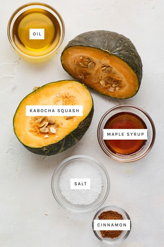 Ingredients measured out to male cinnamon maple roasted kabocha squash: oil, kabocha squash, maple syrup, salt and cinnamon.