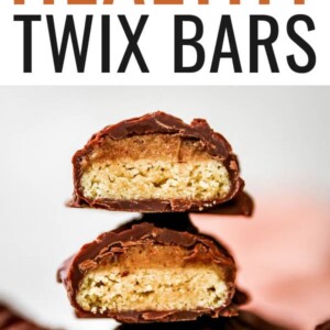 Healthy Twix bars stacked on top of each other. They are cut in half and exposing the inside cookie layer.