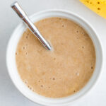 An overhead photo of a bowl of banana puree.