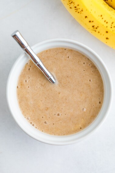 An overhead photo of a bowl of banana puree.