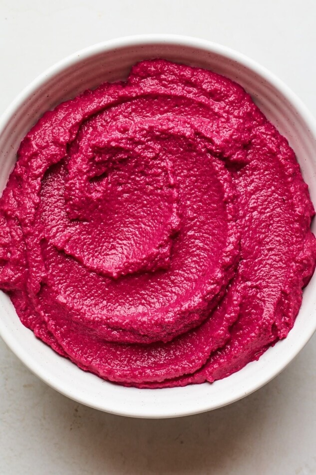 An overhead shot of a bowl of beet hummus.