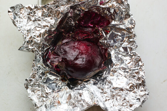 A beet freshly roasted in tin foil.