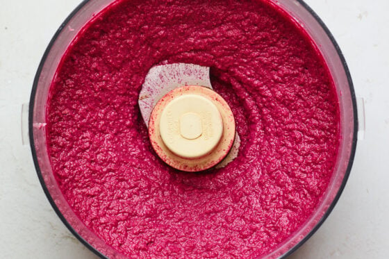 A food processor with freshly made beet hummus.