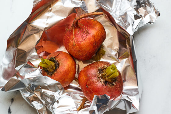 Tin foil with 3 beets inside.
