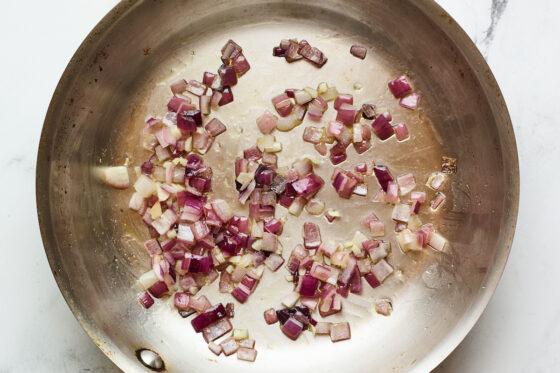 Onions cooked in a sauté pan.