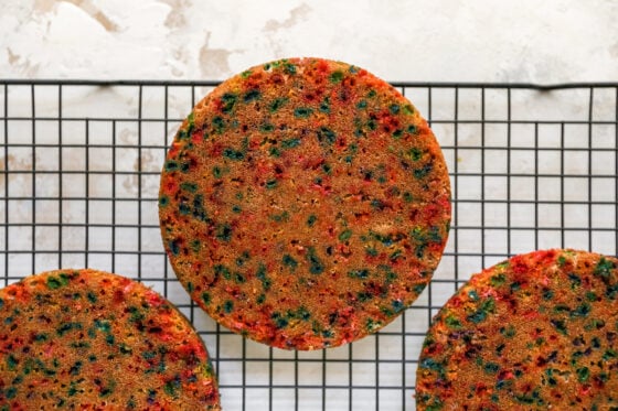 Three cake rounds cooling on a cooling rack.