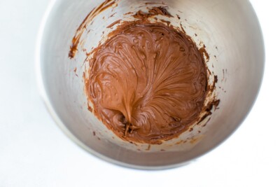 An overhead photo looking into a bowl with freshly whipped chocolate frosting.