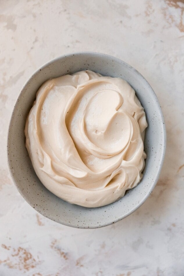 An overhead photo of a bowl of freshly made cream cheese frosting.