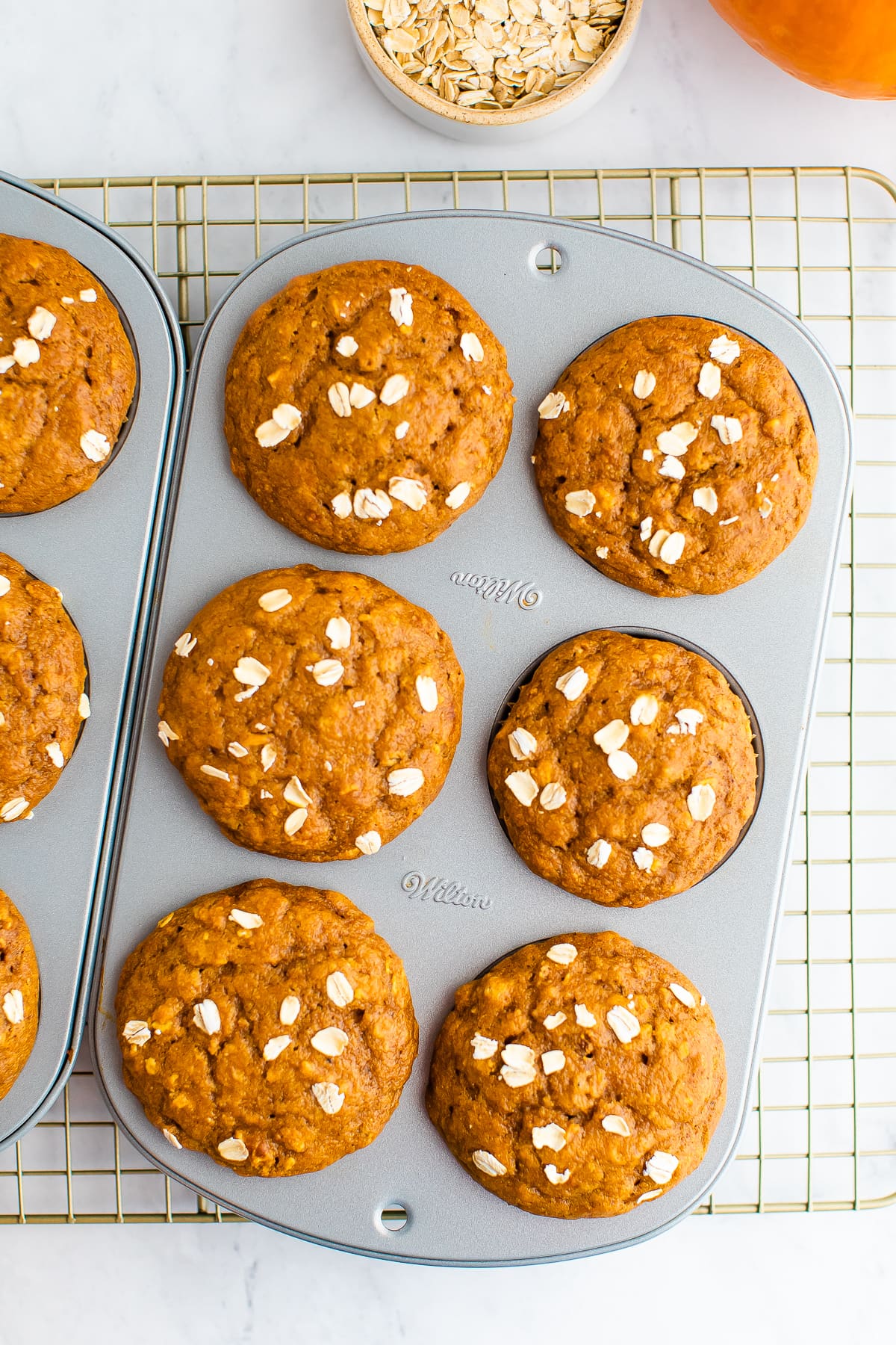 An overhead photo of a 6-muffin baking tin with just baked muffins inside.