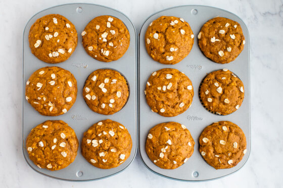 12 freshly baked muffins still in baking tins.