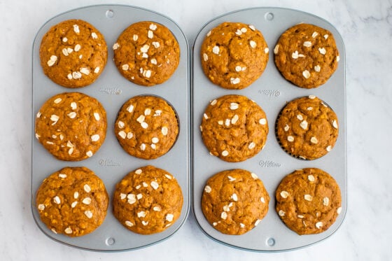 12 freshly baked muffins still in baking tins.