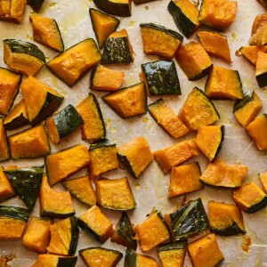 Freshly roasted Kabocha squash chunks on a sheet pan.