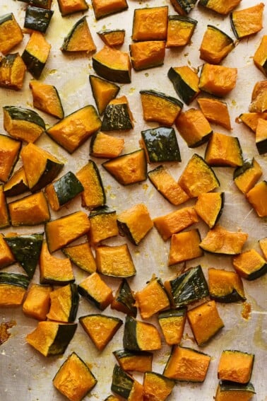 Freshly roasted Kabocha squash chunks on a sheet pan.