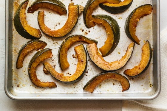 Freshly roasted Kabocha squash on a sheet pan.