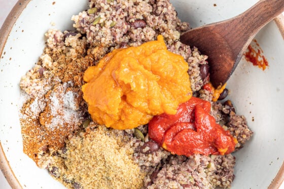 Blended mixture in a bowl with tomato paste, flaxseed, pumpkin puree, toasted sesame oil and spices.