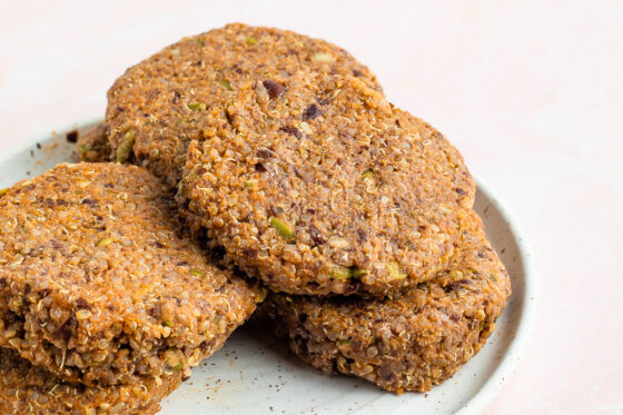 A stack of black bean pumpkin burger patties on a plate.