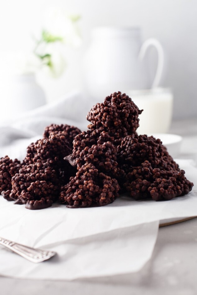 Quinoa crunch bites piled high on a piece of parchment paper.