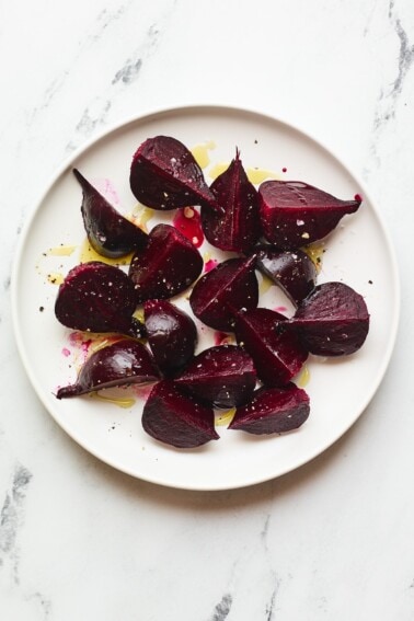 An overhead photo of a plate of quartered roasted beets.