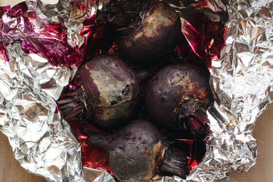 4 beet roots after being roasted in tin foil.