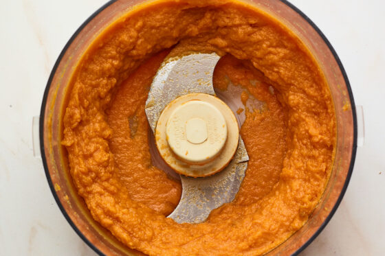 Freshly pureed sweet potatoes in a food processor.