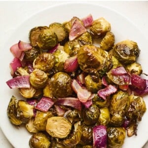 An overhead photo looking down on a plate of apple cider vinegar roasted Brussels sprouts.