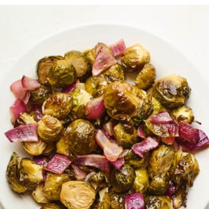 An overhead photo looking down on a plate of apple cider vinegar roasted Brussels sprouts.