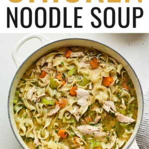 Overhead view of a dutch oven containing chicken noodle soup.