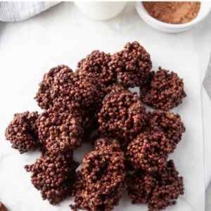 An overhead photo looking at chocolate quinoa crunch bites piled onto pieces of overlapping parchment paper.
