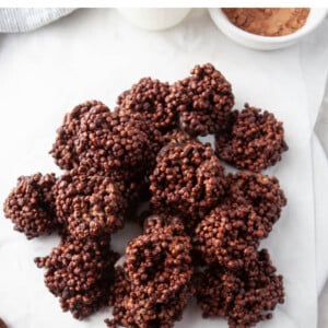 An overhead photo looking at chocolate quinoa crunch bites piled onto pieces of overlapping parchment paper.