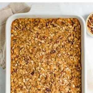 Overhead view looking at a rectangular baking dish containing healthy sweet potato casserole topped with a crunchy pecan and brown sugar topping.